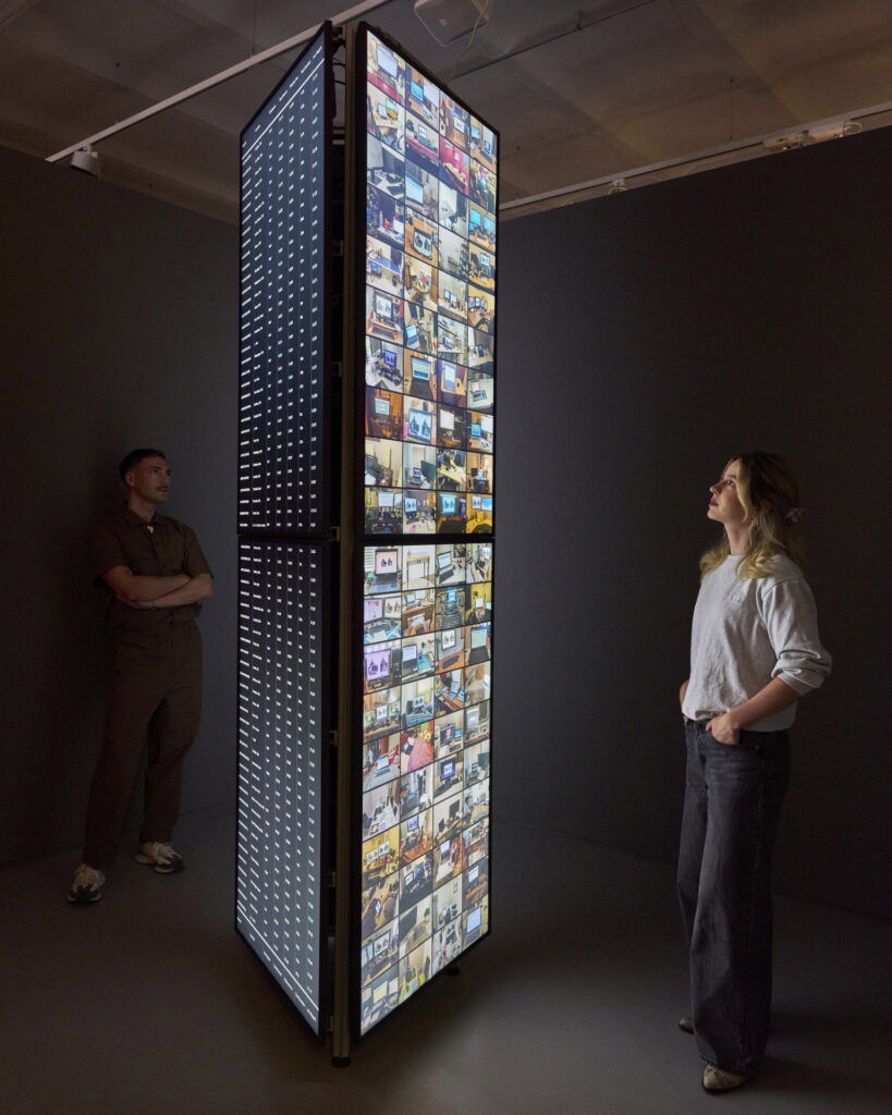 Two people view Meta Office “Behind the Screens of Amazon Mechanical Turks” in the SCHIRN exhibition The World Through AI.